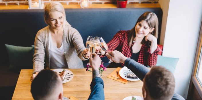 Group of friends toasting in a restaurant.